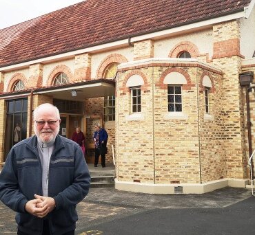 Father Leonard Danvers outside church